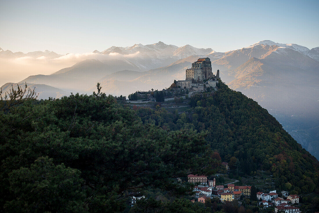 Sacra di San Michele at Sunset with Alps in Background and Village of San Pietro Below, Italy