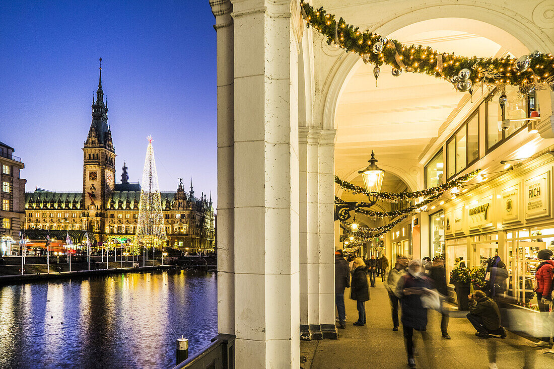 Christmas market and illuminations at the town hall in Hamburg and view to the Alster Arkaden, north Germany, Germany