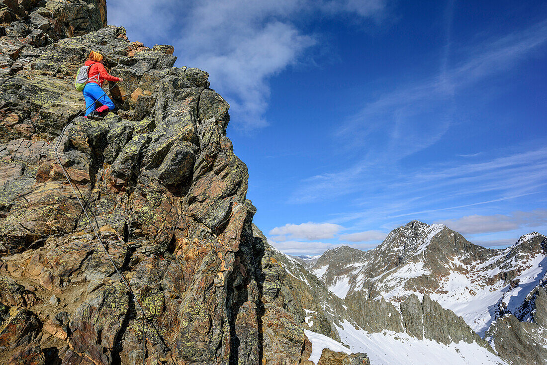 Woman hiking ascending on fixed rope route towards Gloedis, Gloedis, Schober Range, High Tauern, High Tauern National Park, East Tyrol, Tyrol, Austria