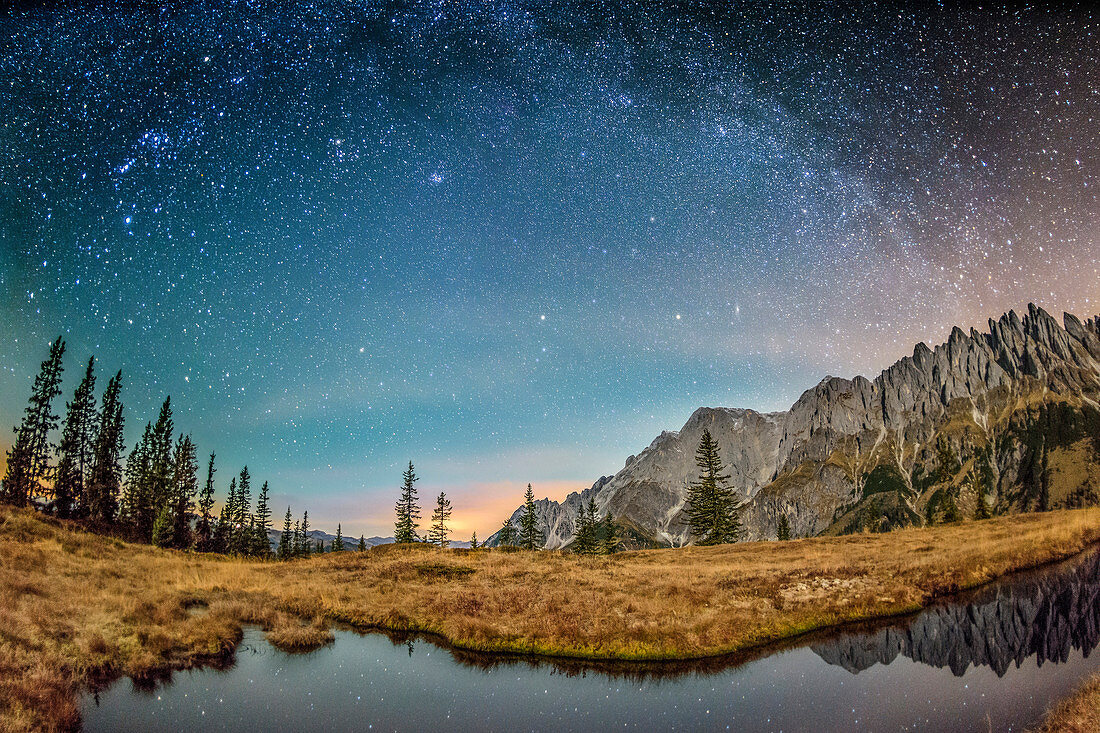 Stary sky with milky way above lake with Steinernes Meer range and Hochkoenig in background, Hochkoenig range, Berchtesgaden Alps, Salzburg, Austria