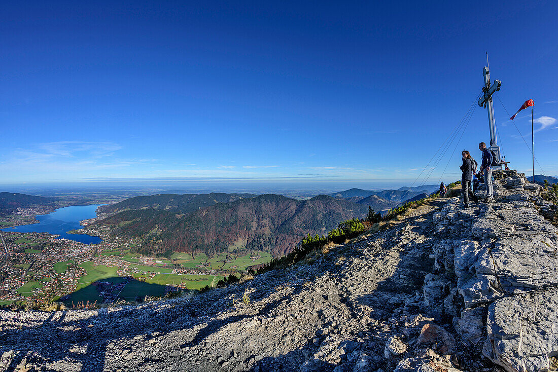 Several persons standing at summit of Wallberg and looking towards lake Tegernsee, view from Wallberg, Wallberg, Bavarian Alps, Upper Bavaria, Bavaria, Germany