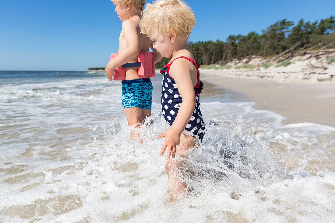 Young sister and her brother playing in the waves, dream beach between Strandmarken und Dueodde, sandy beach, baltic sea, MR, Bornholm, Strandmarken, Denmark, Europe