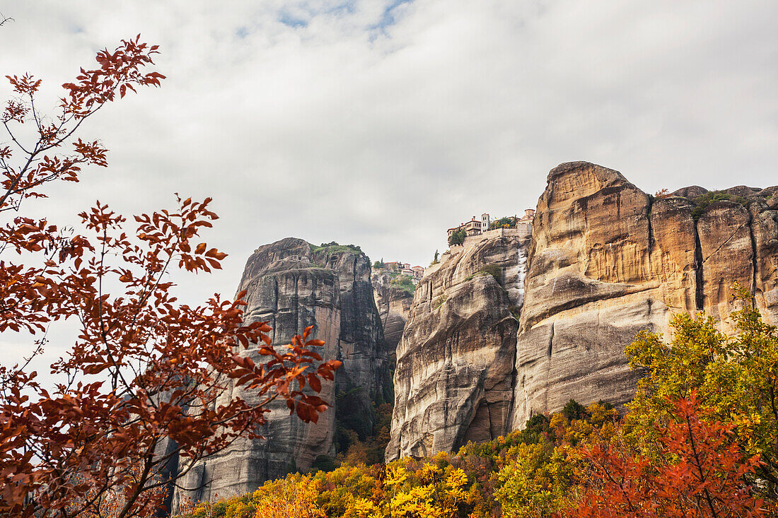 Monastery perched on a cliff with autumn foliage, Meteora, Greece