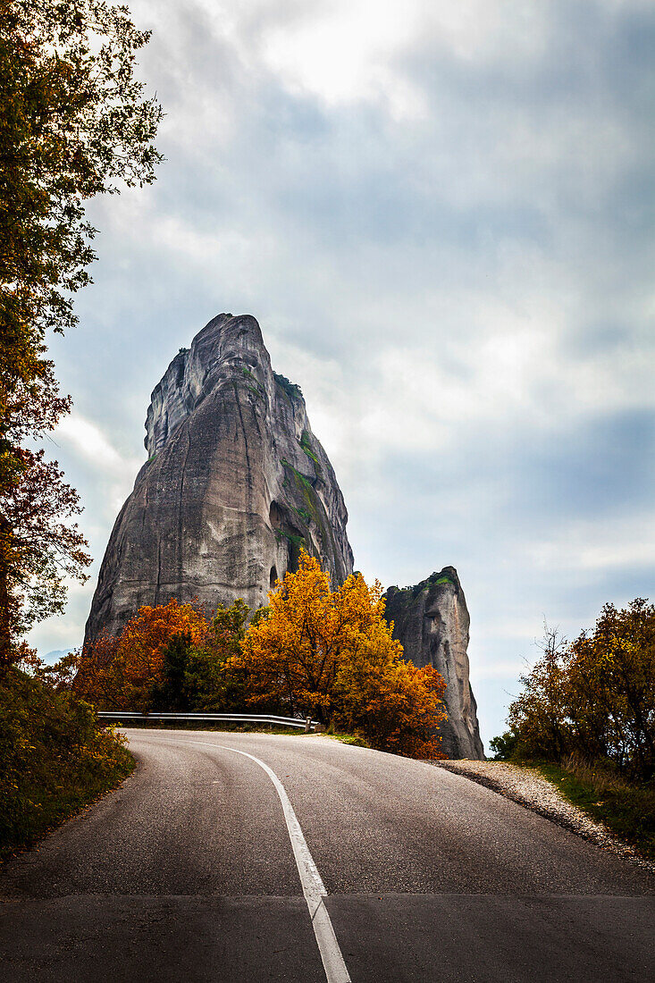 Rugged cliffs, road and autumn foliage, Meteora, Greece