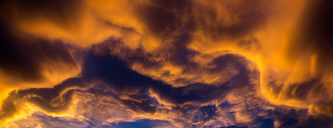 Dramatic colourful clouds at sunset with interesting formations and some blue sky, Calgary, Alberta, Canada