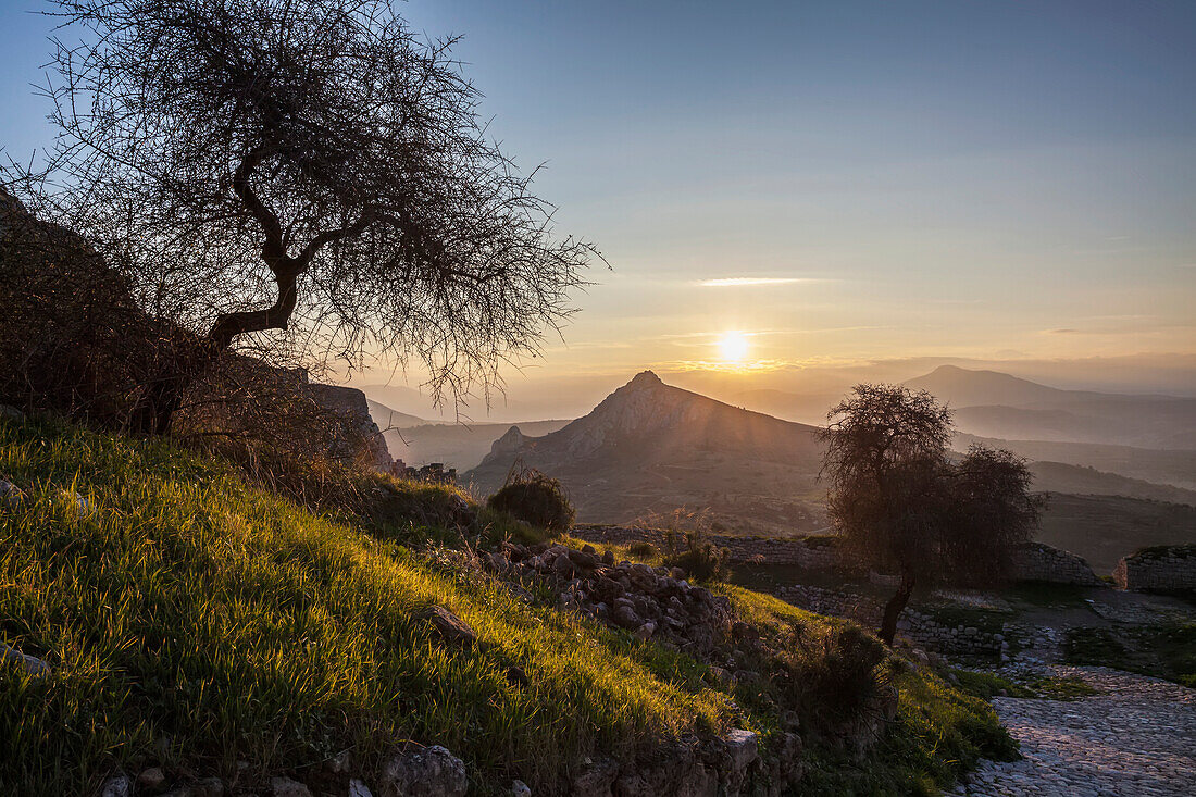 Sun setting over the peaks of mountains, Corinth, Greece