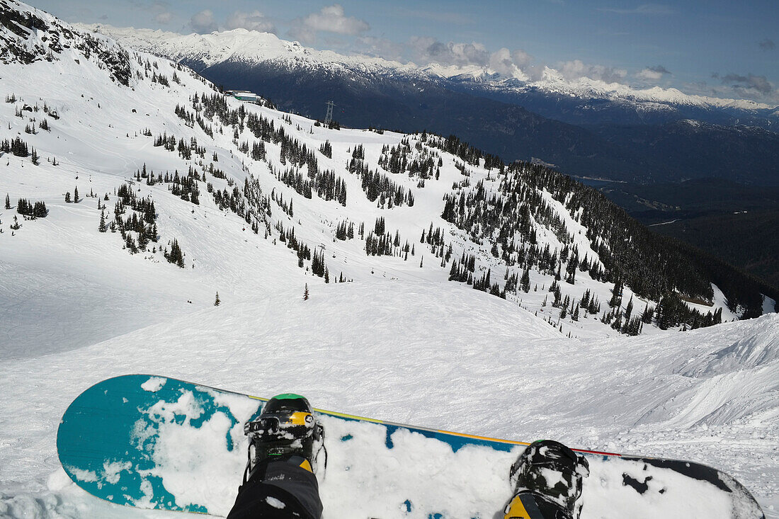 Snowboard and boots with a view from a chairlift, Whistler, British Columbia, Canada
