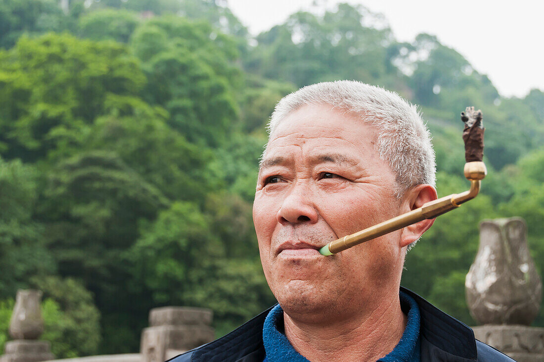 A man smoking in Leshan Giant Buddha scenic area, Sichuan Province, China