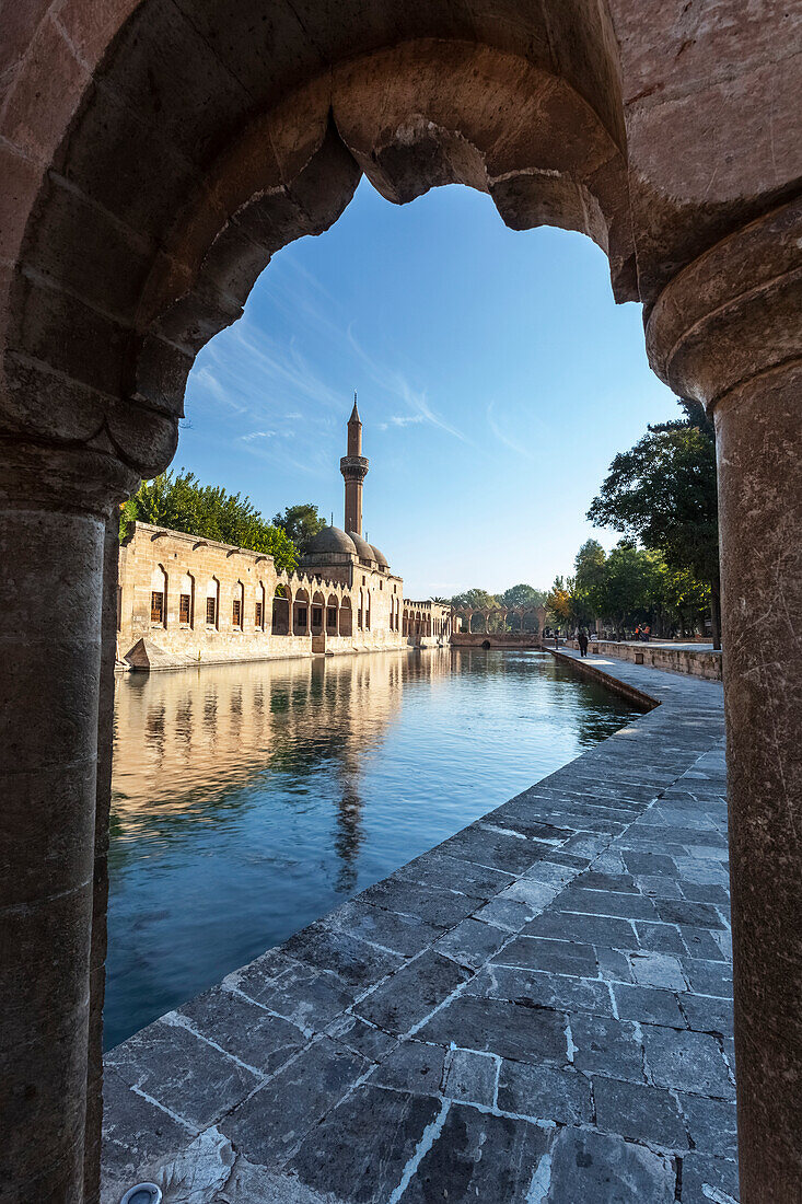 Chamber of Abraham and a minaret reflected in the tranquil water of a lake, Sanliurfa, Turkey
