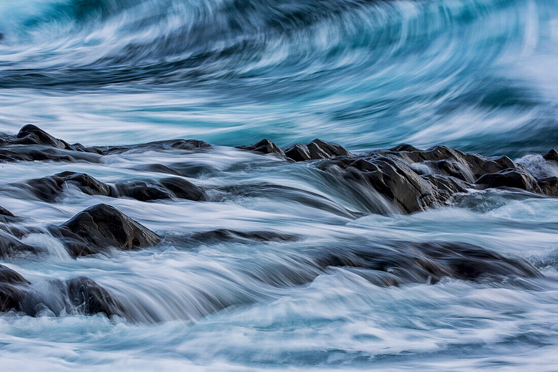 Long exposure of waves striking the coastline and flowing over rocks, Iceland