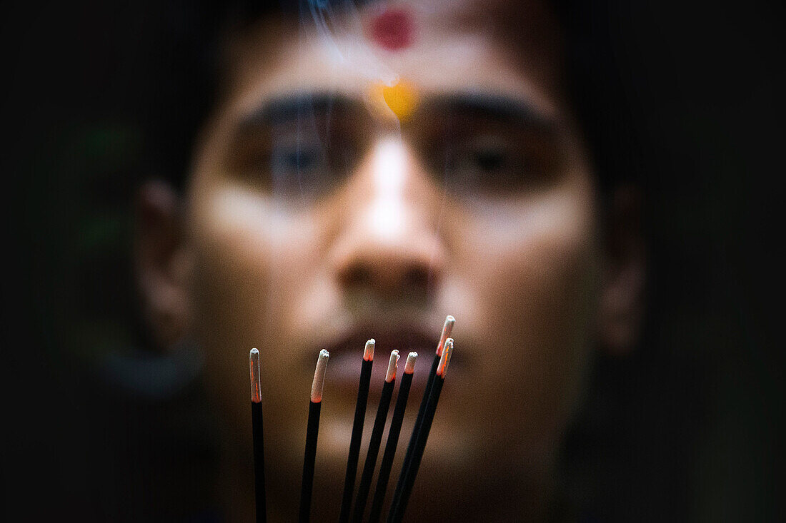 Portrait of a Hindu Priest with incense sticks, Goa, India