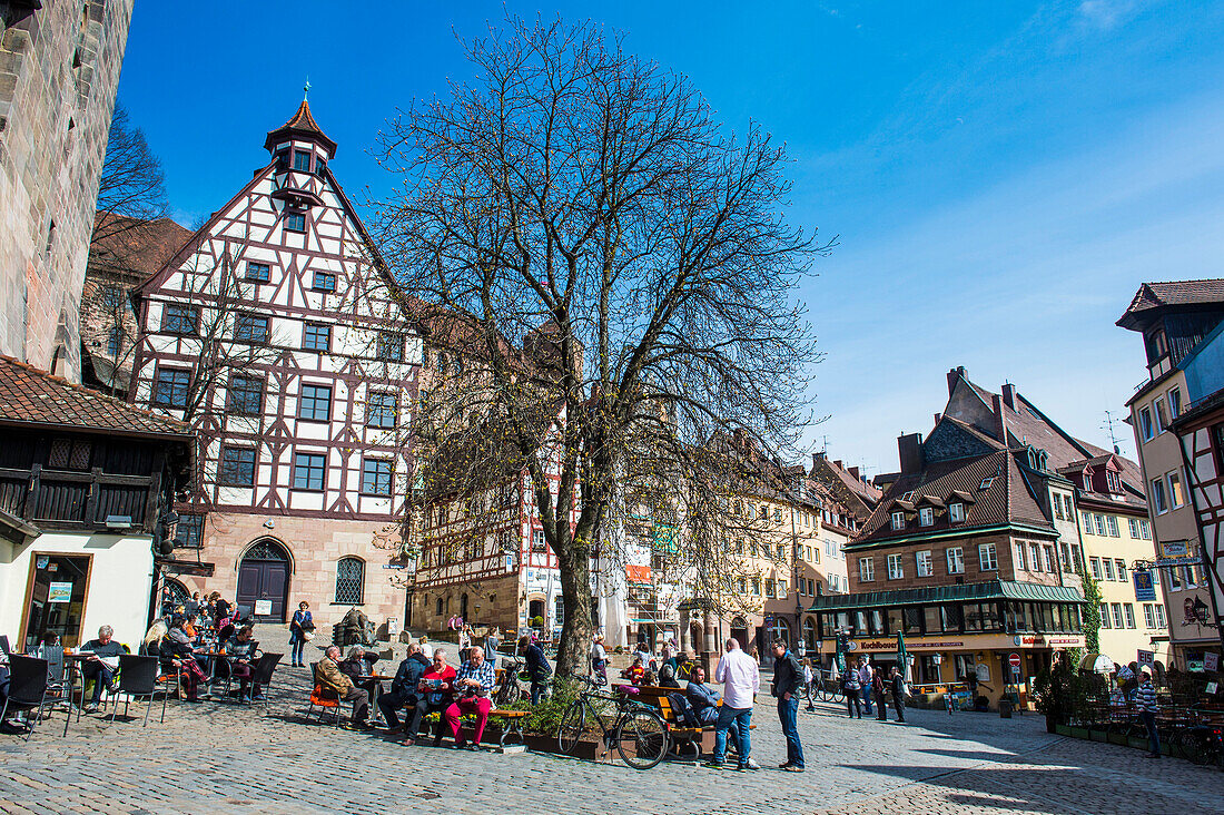 Half timbered houses and open air cafes on Albrecht Duerer square in the medieval town center of the town of Nuremberg, Bavaria, Germany, Europe