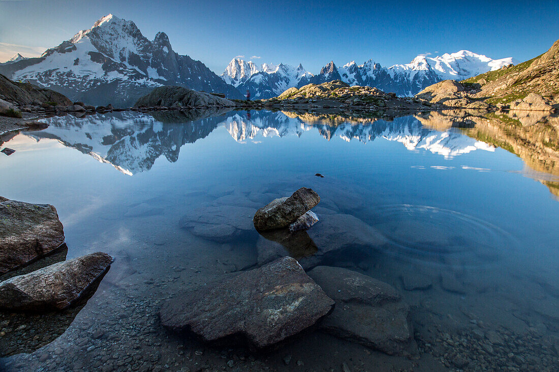 Snowy peaks of Aiguilles Verte, Dent Du Geant, and Mont Blanc are reflected in Lac Blanc, Haute Savoie, French Alps, France, Europe