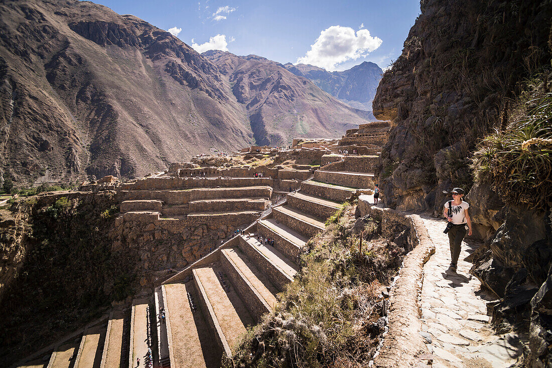 Woman exploring Inca Ruins of Ollantaytambo, Sacred Valley of the Incas Urubamba Valley, near Cusco, Peru, South America