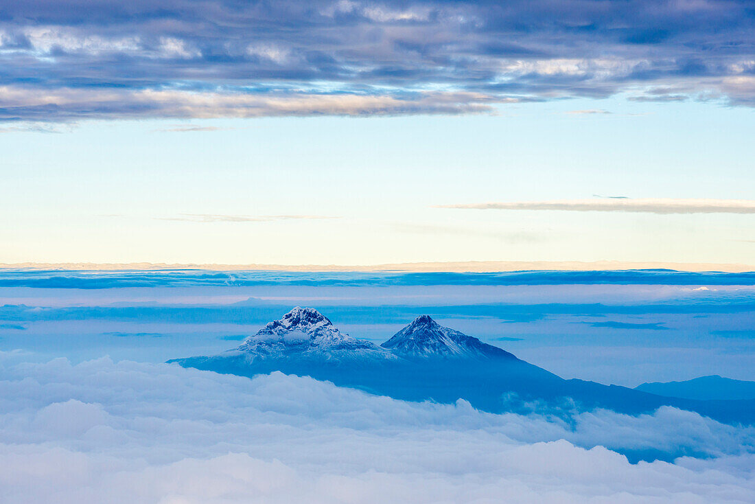 Volcanoes of Illiniza Norte, 5126m on left and Illiniza Sur, 5248m on right, seen from Cotopaxi Volcano 5897m summit, Cotopaxi Province, Ecuador, South America