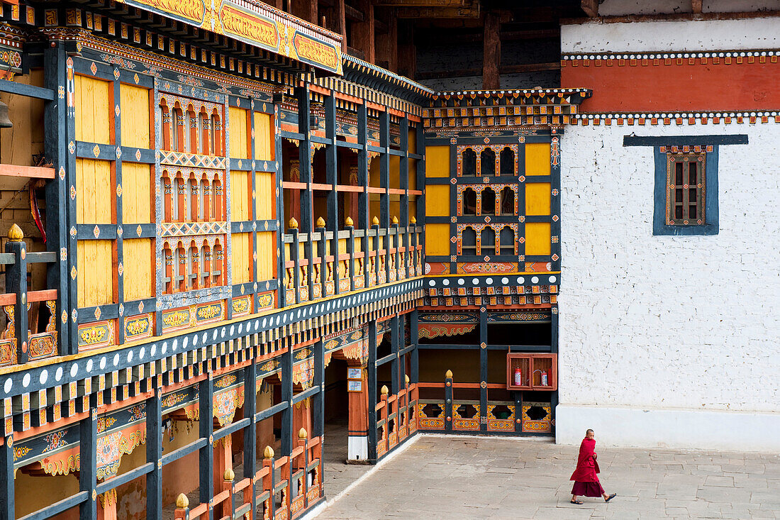 Monk walking through Rinpung Dzong, Paro District, Bhutan, Asia