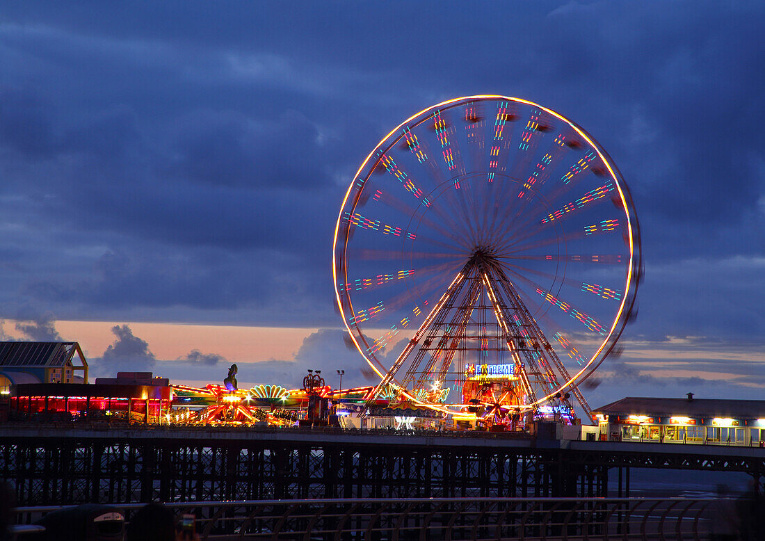 Big wheel and funfair on Central Pier lit at dusk, Blackpool Illuminations, Blackpool, Lancashire, England, United Kingdom, Europe