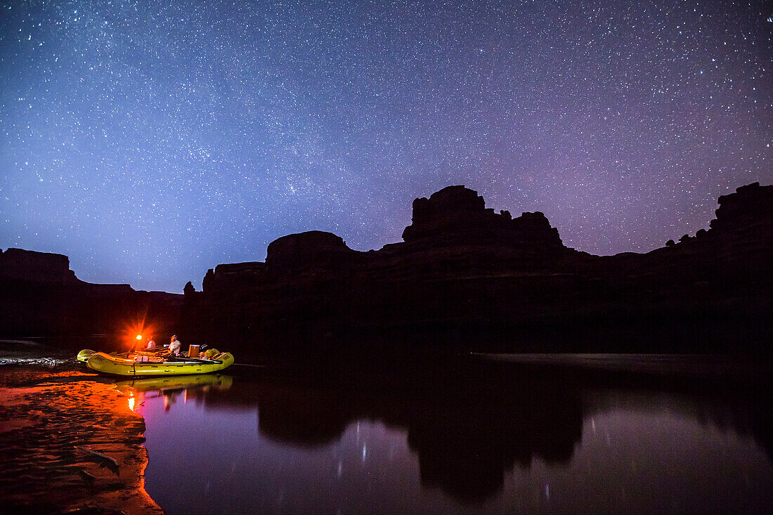 Rafts and camp along the Colorado river at night. Photo taken during a rafting trip down Cataract Canyon, Utah.