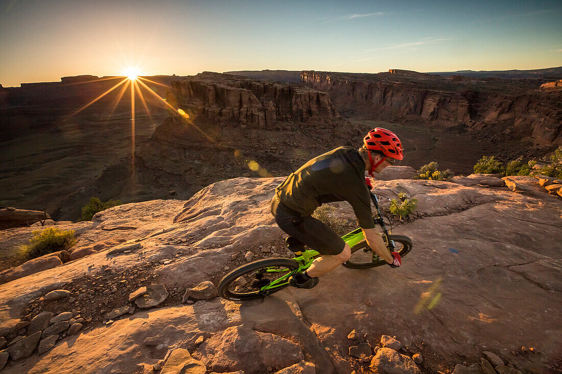 A man mountain biking on the Hymasa trail, Moab, Utah.
