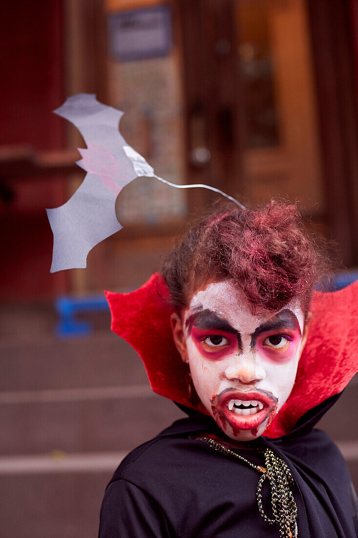 Mixed race girl wearing vampire costume