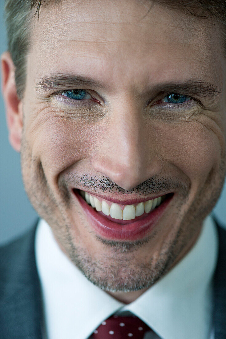 Businessman smiling cheerfully, portrait