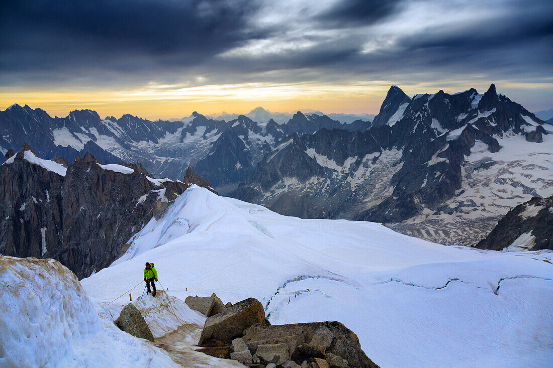 roped guide at the foot of the aiguille du midi, sunrise over the mont-blanc, chamonix-mont-blanc, upper savoy, haute-savoie (74), rhone-alpes, france