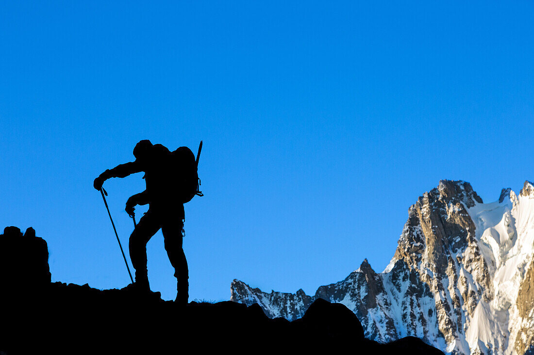 mountain climber at daybreak in front of the mont dolent, col du tour noir pass, argentiere, refuge d'argentiere, upper savoy, haute-savoie (74), rhone-alpes, france