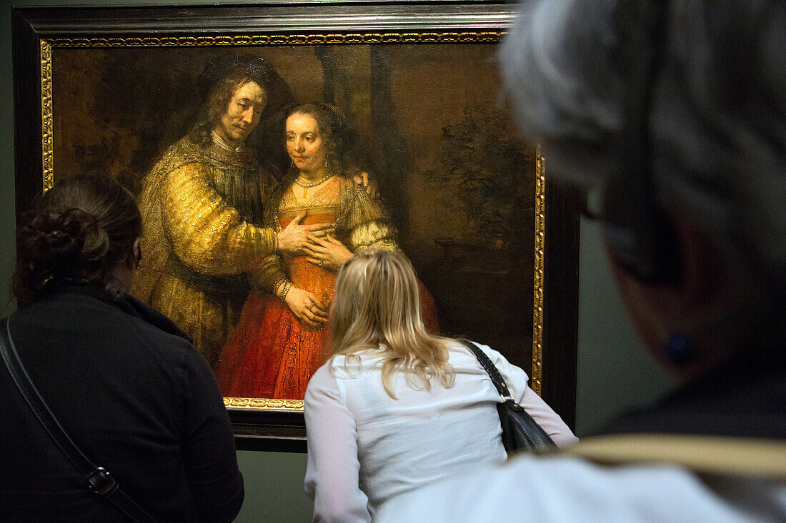 visitors at the rembrandt exhibition, the painting isaac and rebecca or the jewish bride, rijksmuseum, amsterdam, holland