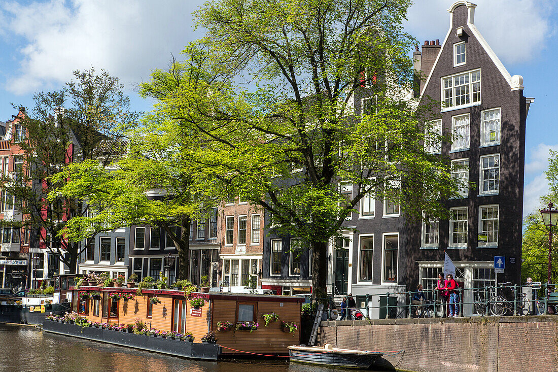 characteristic scene around the princengracht canal (houseboats and typical buildings), amsterdam, holland