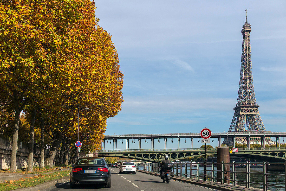 the eiffel tower and a street along the riverbanks lined with trees in autumn colors, paris (75), france