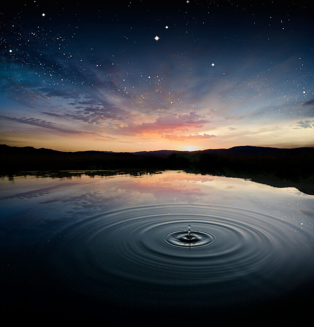 Ripple in rural pond reflecting sunrise sky