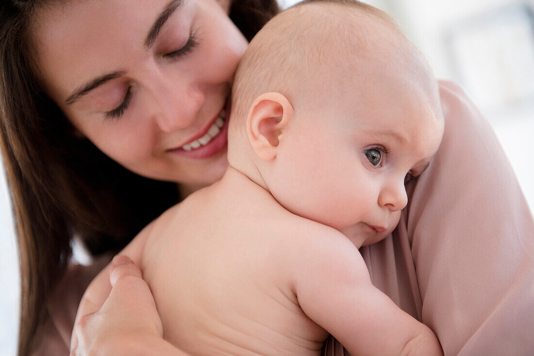 Close up of mother holding baby girl
