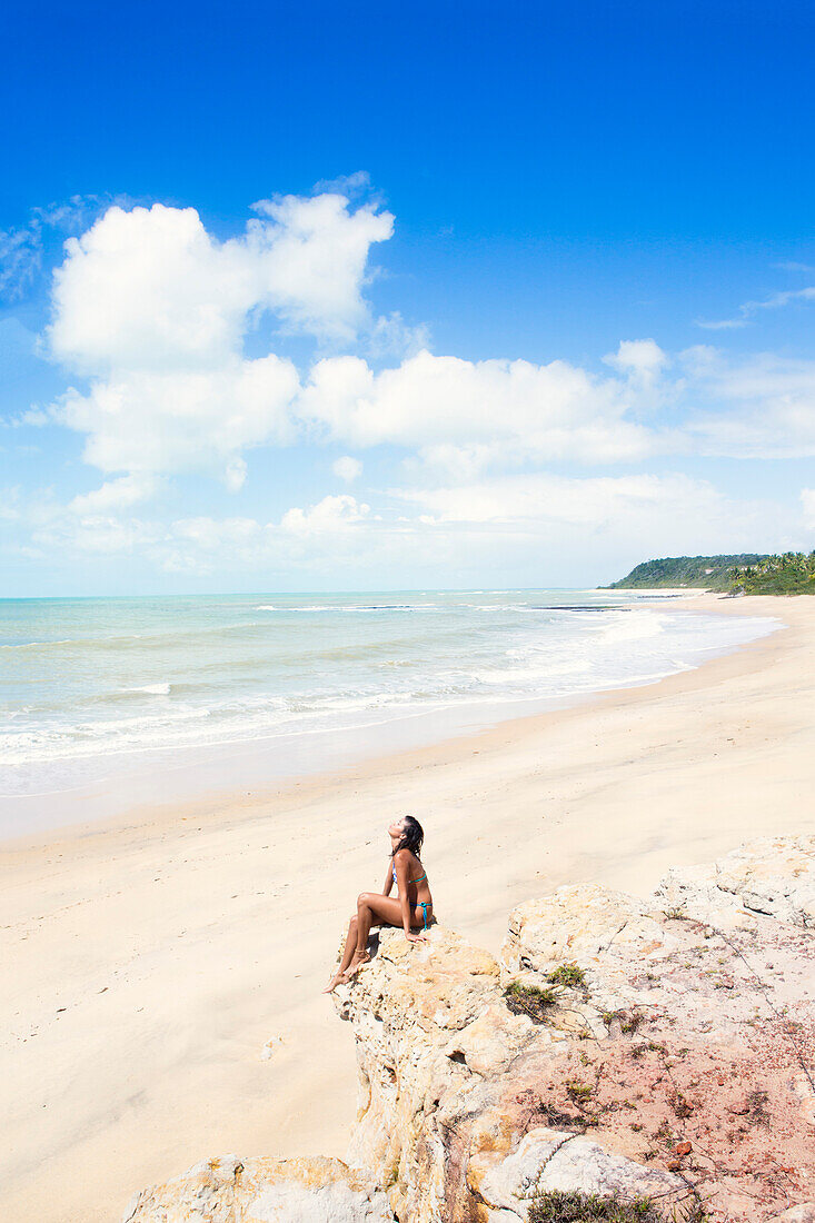 A young woman on Espelho near Trancoso, Bahia, Brazil, South America