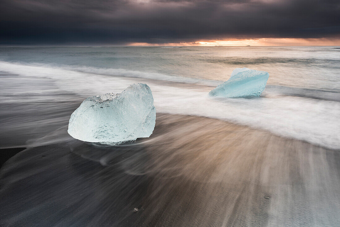 Icebergs at sunrise on Jokulsarlon Beach, a black volcanic sand beach in South East Iceland, Iceland, Polar Regions