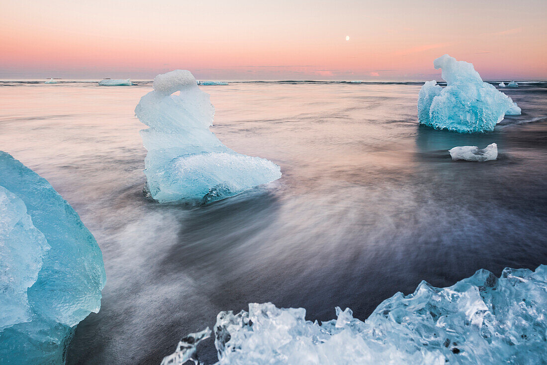 Icebergs at sunset on Jokulsarlon Beach, a black volcanic sand beach in South East Iceland, Iceland, Polar Regions