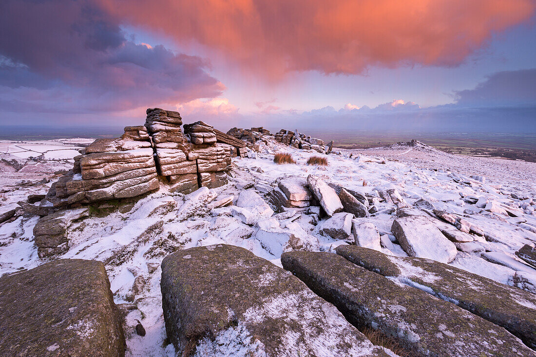 Colourful sunrise above snow covered moorland, Belstone Tor, Dartmoor, Devon, England, United Kingdom, Europe