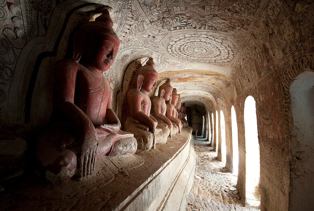 Buddha statues in one of the 947 Hpowindaung sandstone caves, 18th century paintings on the walls, Monywa, Sagaing District, Myanmar Burma, Asia