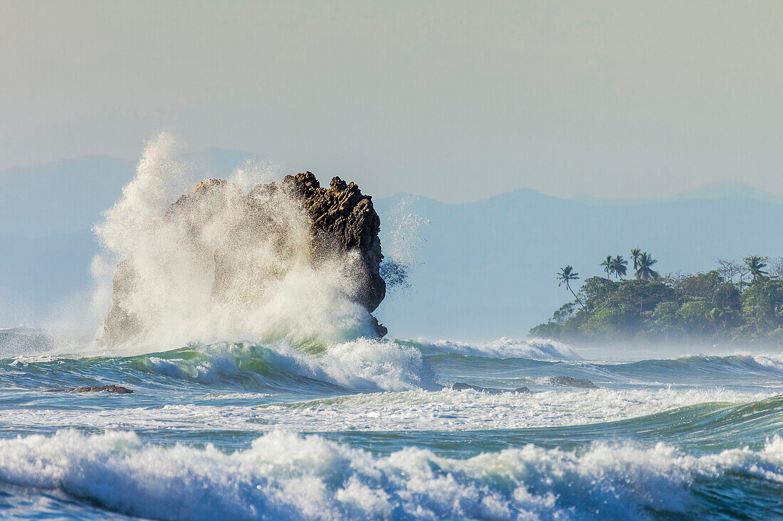 Surf on a sea stack between Santa Teresa and Hermosa beaches, far south Nicoya Peninsula, Santa Teresa, Puntarenas, Costa Rica, Central America