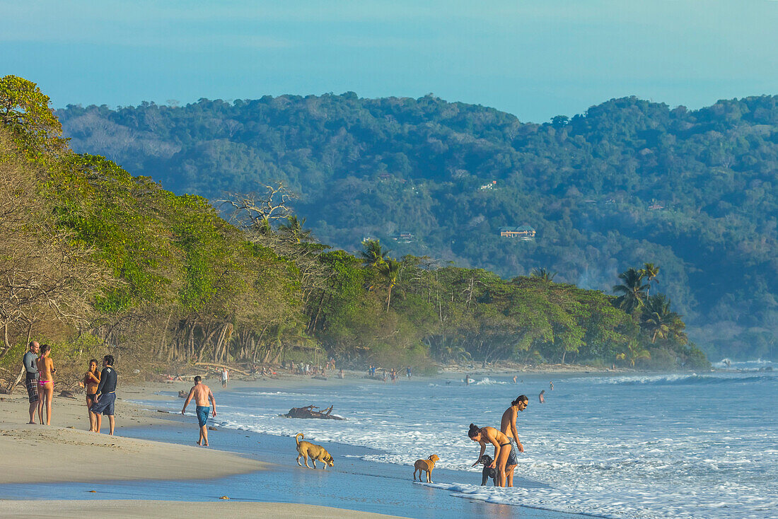 Beach walkers at this hip surf resort near Mal Pais, far south end of the Nicoya Peninsula, Santa Teresa, Puntarenas, Costa Rica, Central America