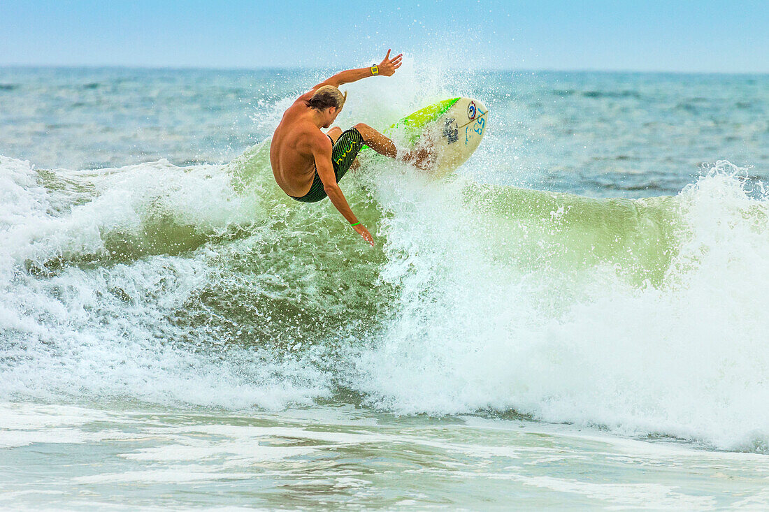 Shortboard surfer riding a wave at this surf resort on the south coast of Nicoya Peninsula, Santa Teresa, Puntarenas, Costa Rica, Central America