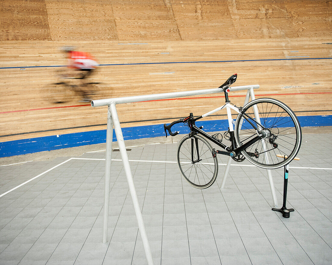 Bicycle hanging on rack at sports track