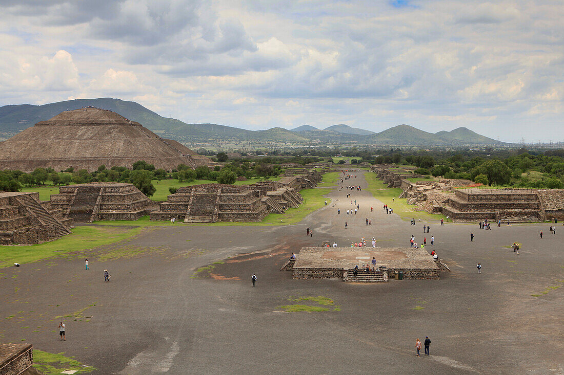 High angle view of people on street by Pyramid of the Sun against cloudy sky