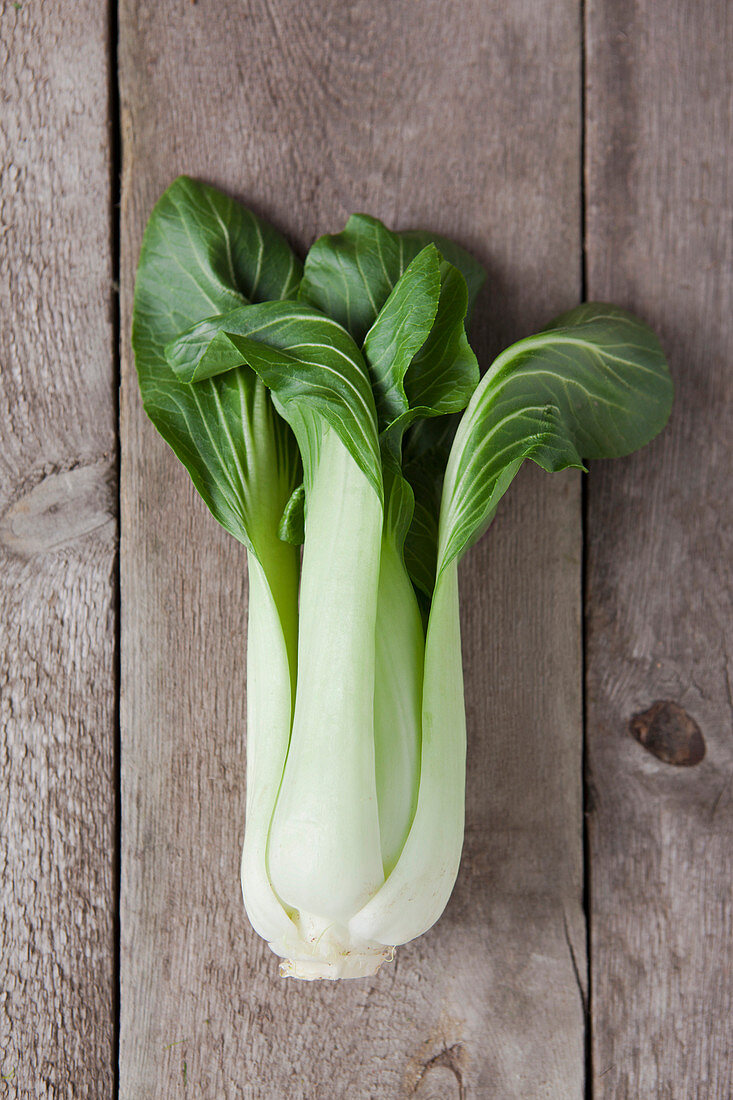 Directly above of bok choy on wooden table