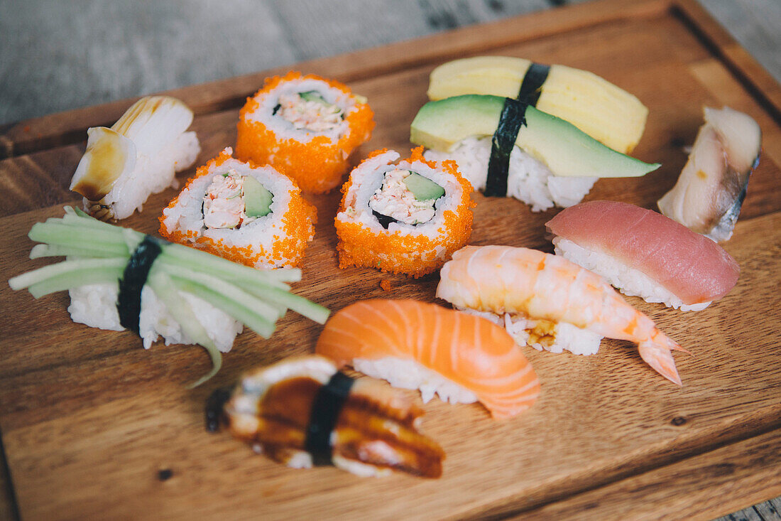High angle view of various sushi on cutting board