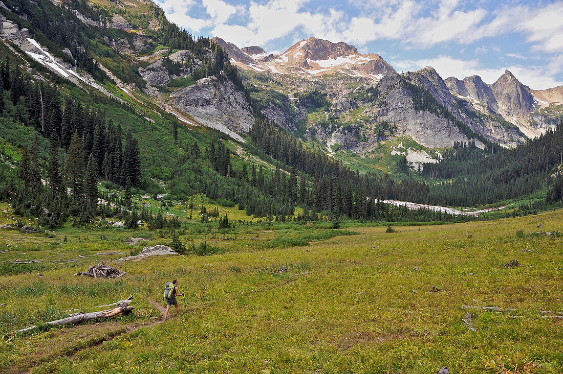 Woman hikes through Spider Meadow at the base of 7.646-foot Red Mountain on the Phelps Creek Trail, 14.2-mile out-and-back, in the Glacier Peak Wilderness outside of Leavenworth, Washington September 2011.  Phelps Creek leads to the base of Spider Glacier