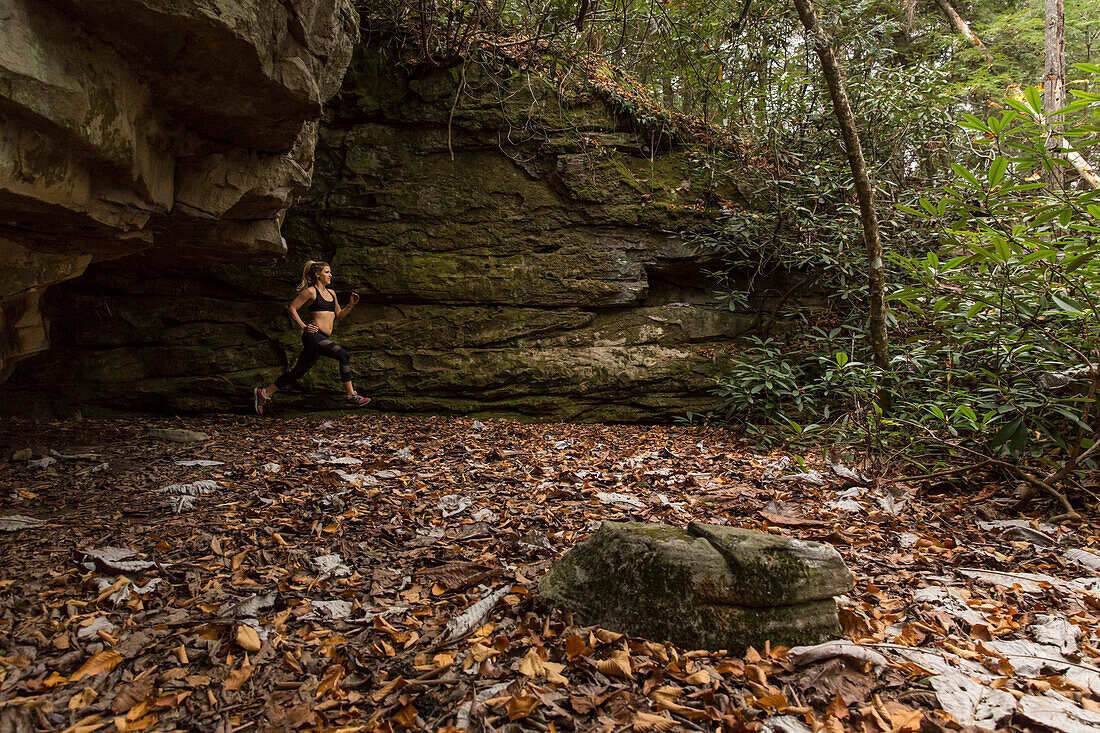 active female running through the forest in The Obed, Tennessee