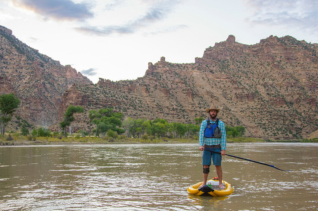 Standup paddleboarder in Desolation Canyon along the Green River, Utah.