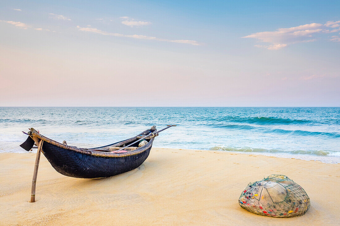 Traditional bamboo basket fishing boat on the beachat at sunset, Thu?n An Beach, Phú Vang District, Th?a Thiên-Hu? Province, Vietnam