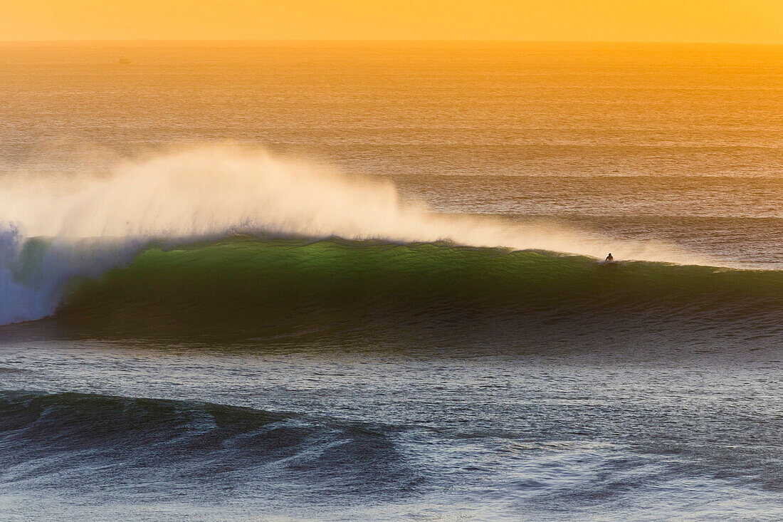 Lonely surfer and  ocean wave.