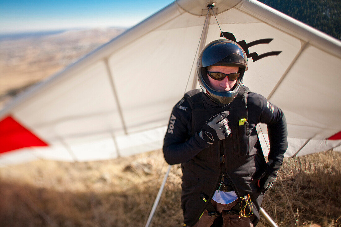 World record hang glider, BJ Herring checks his radio while on launch on at Lookout Mountain in Golden, Colorado.